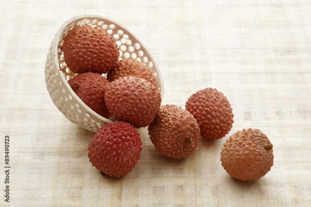Lychees falling out of a bowl Lychees falling out of a bowl