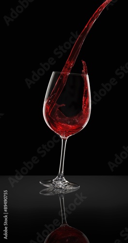 Red wine being poured from a bottle into a glass