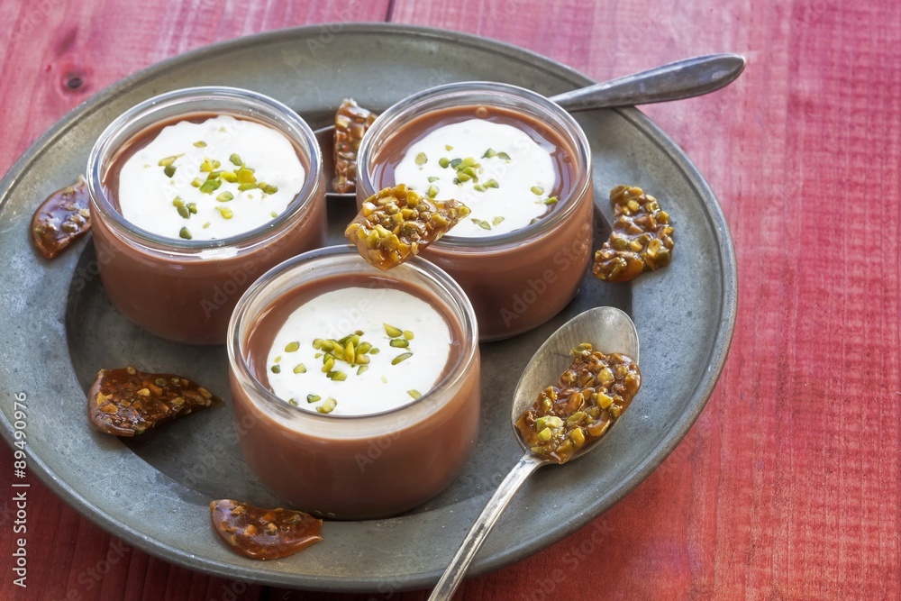 Chocolate creme topped with whipped cream, pistachios and pistachio caramel