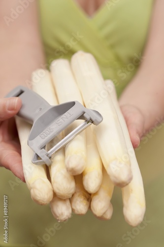 Hands holding peeled white asparagus