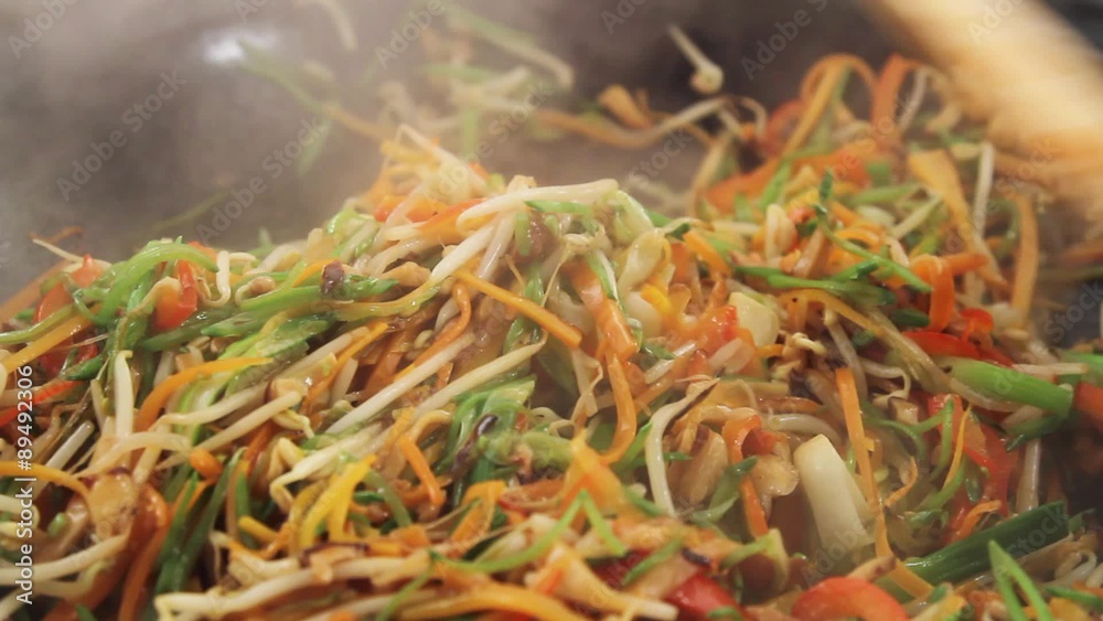 Stir-frying vegetables in a wok Stir-frying vegetables in a wok