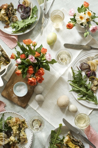 Easter Table with Full Dinner Plates, Flowers, Eggs and Wine; From Above photo