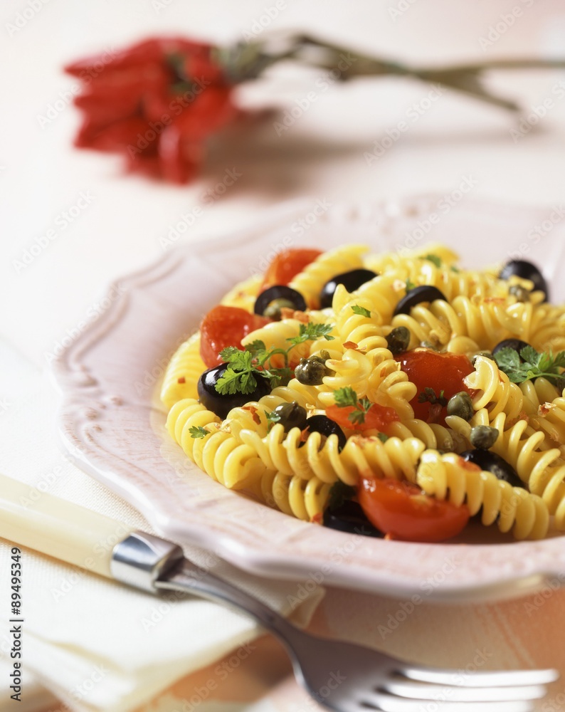 Pasta with black olives, capers, cherry tomatoes and parsley