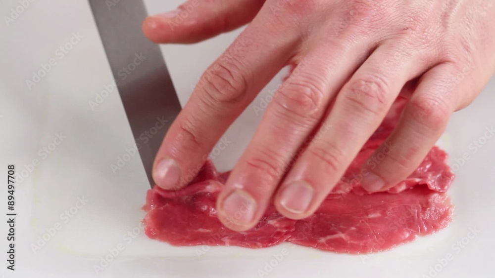 Beef fillet carpaccio being arranged on a plate Beef fillet carpaccio being arranged on a plate