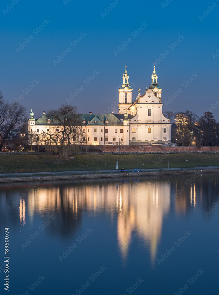 Krakow, Poland, scenic Vistula riverbank with Pauline fathers church (Skalka) in the evening