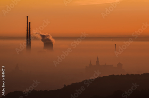City at dawn, covered with fog and smog, right after sunrise, Krakow, Poland.