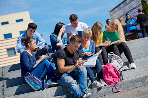 students outside sitting on steps photo