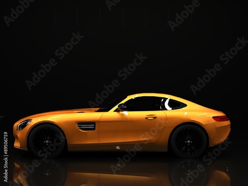Sports car left view. The image of a sports gold car on a black background. photo