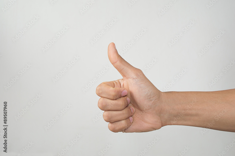 Closeup of male hand showing thumbs up sign