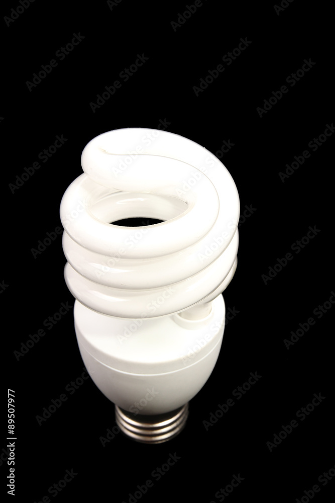 Spiraled Energy efficient light bulb on black background Spiraled Energy efficient light bulb on black background