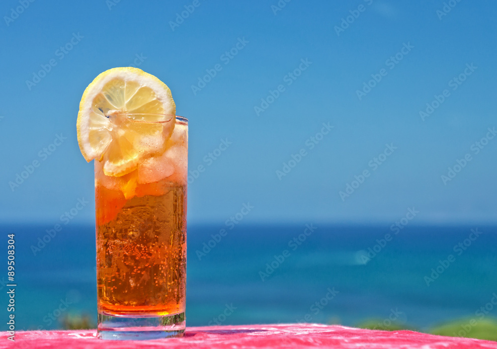 Cocktail drink in front of summer sea and sky background Cocktail drink in front of summer sea and sky background