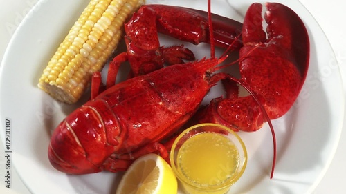Cooked lobster with corn on the cob and butter sauce