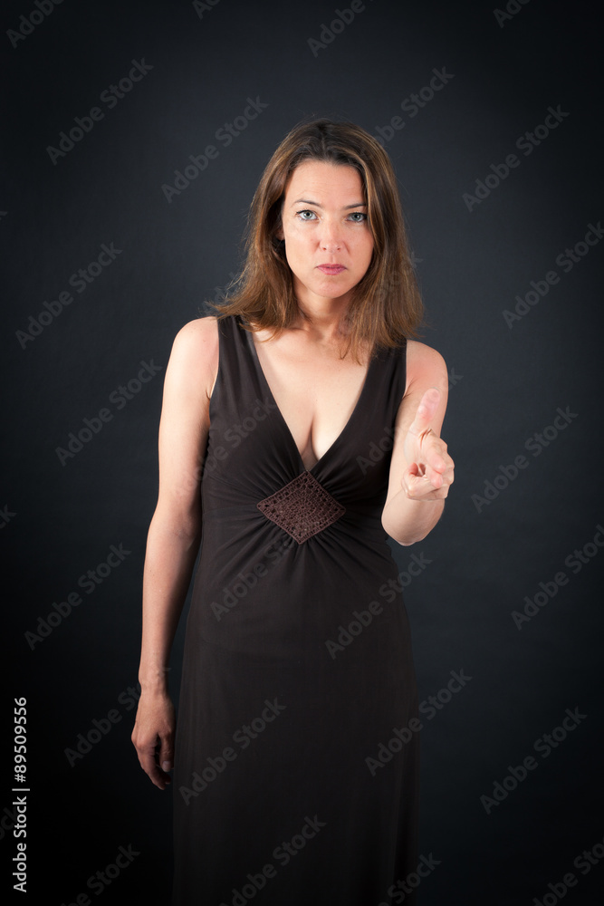 Beautiful woman doing different expressions in different sets of clothes: gun sign Beautiful woman doing different expressions in different sets of clothes: gun sign