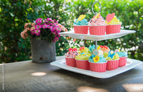 colorful of cup cakes on shelf dish