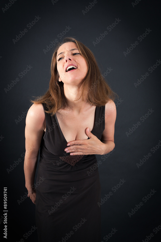 Beautiful woman doing different expressions in different sets of clothes: heart attack Beautiful woman doing different expressions in different sets of clothes: heart attack