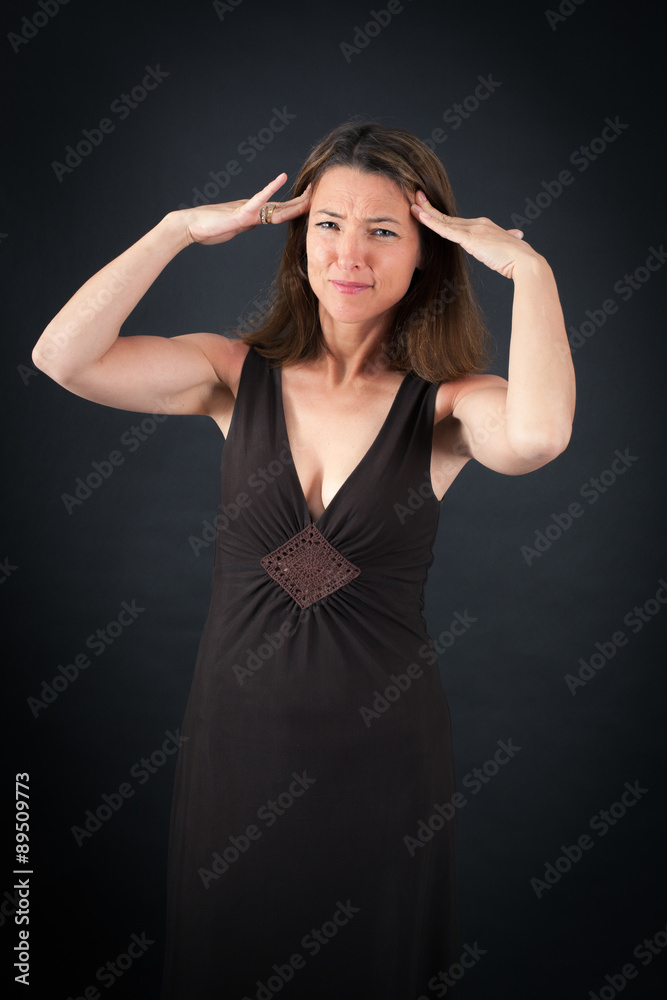 Beautiful woman doing different expressions in different sets of clothes: headache Beautiful woman doing different expressions in different sets of clothes: headache