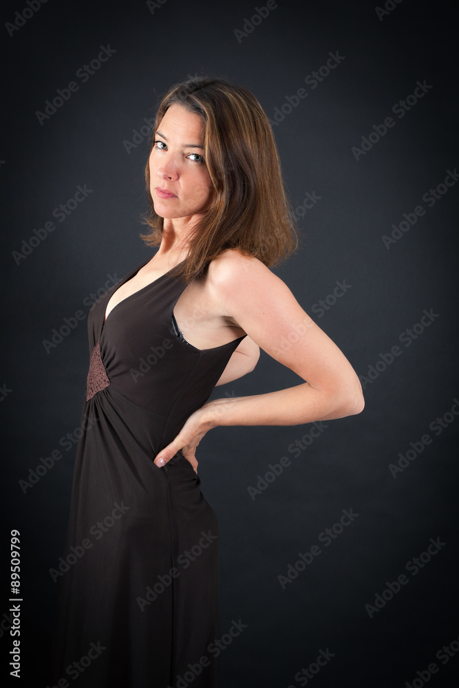 Beautiful woman doing different expressions in different sets of clothes: backache Beautiful woman doing different expressions in different sets of clothes: backache