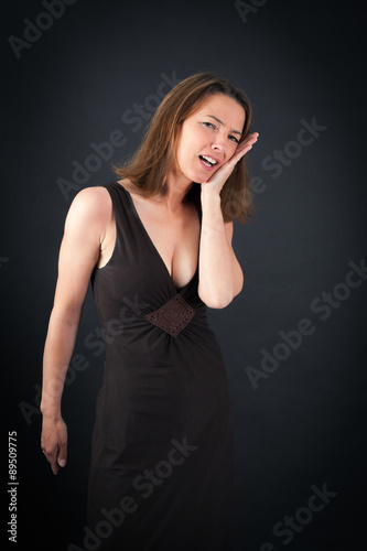 Beautiful woman doing different expressions in different sets of clothes: toothache