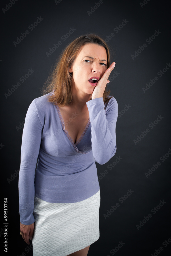 Beautiful woman doing different expressions in different sets of clothes: toothache Beautiful woman doing different expressions in different sets of clothes: toothache