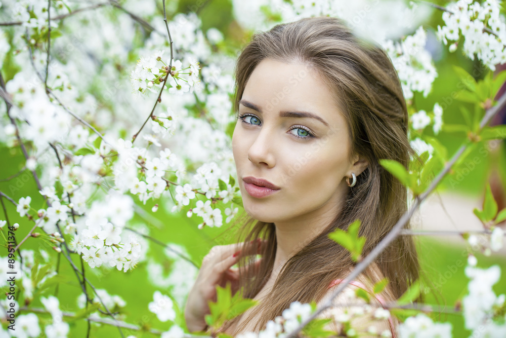 Portrait of beautiful young brunette woman in spring blossom Portrait of beautiful young brunette woman in spring blossom