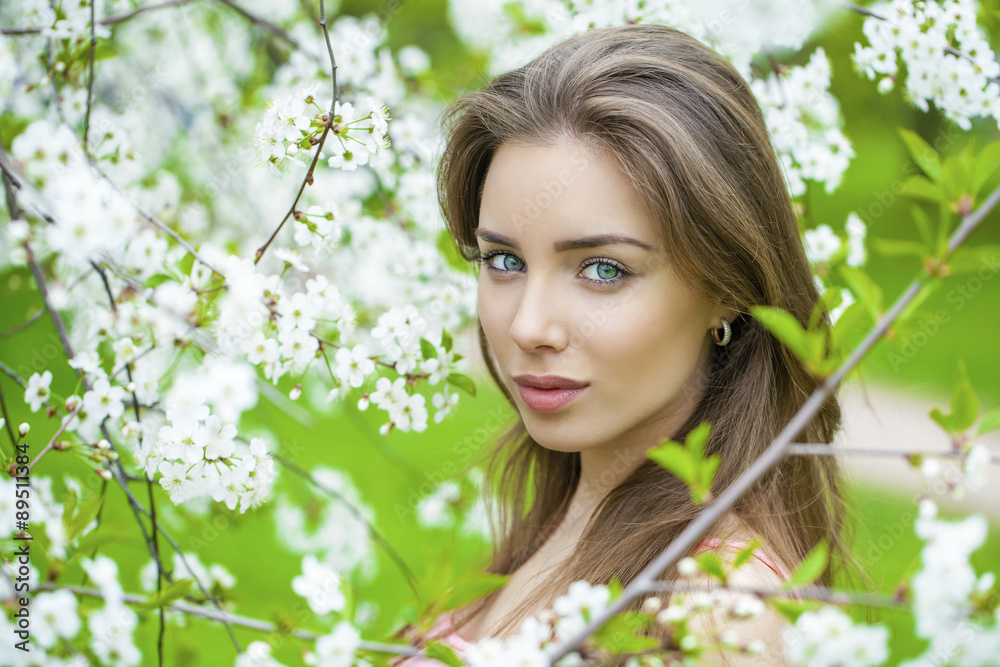 Portrait of beautiful young brunette woman in spring blossom Portrait of beautiful young brunette woman in spring blossom