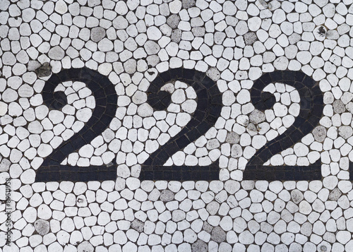 The number two hundred and twenty two in black on white tile photo