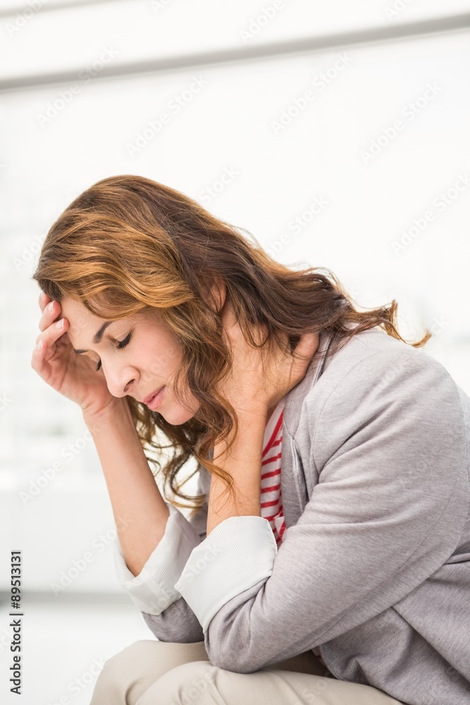 Overworked casual businesswoman having a headache Overworked casual businesswoman having a headache