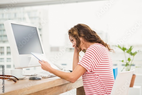 Tired casual businesswoman working with tablet