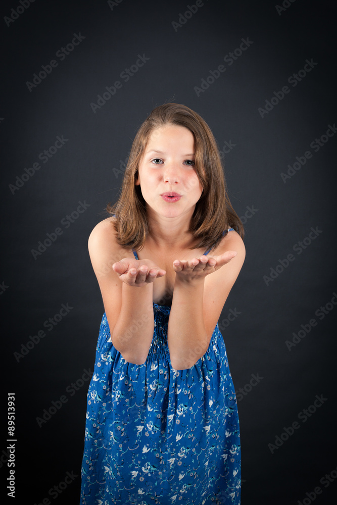 Obraz premium Beautiful girl doing different expressions in different sets of clothes: kiss