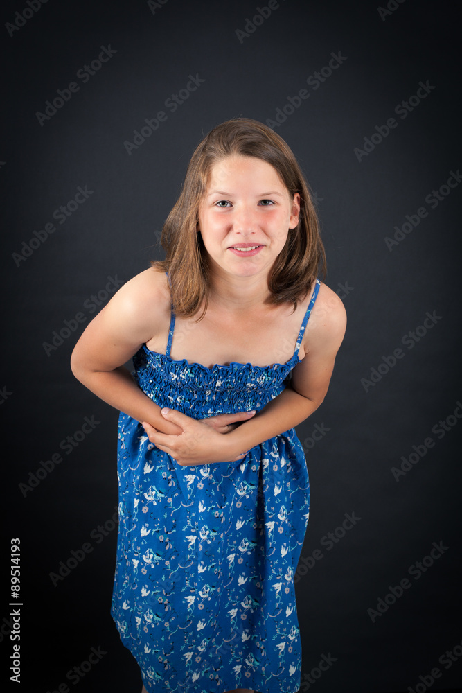 Beautiful girl doing different expressions in different sets of clothes: stomachache Beautiful girl doing different expressions in different sets of clothes: stomachache