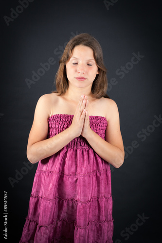 Beautiful girl doing different expressions in different sets of clothes: prayer
