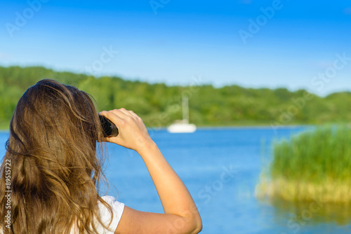 Close-up woman hold binocular outdoor. Shallow depth, focus on t