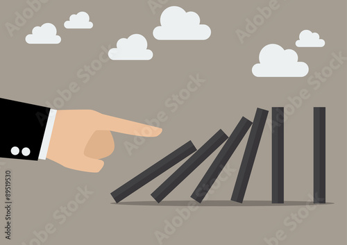 Businessman hand pushing the domino tiles