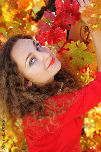 Pretty Girl with curly shiny hair in yellow grape vineyard