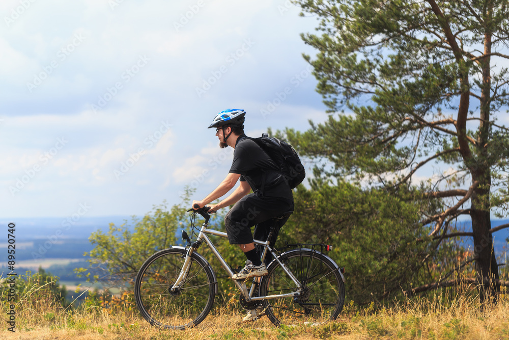 Biking in the Franconian Hills in Northern Bavaria. Young man on Biking in the Franconian Hills in Northern Bavaria. Young man on