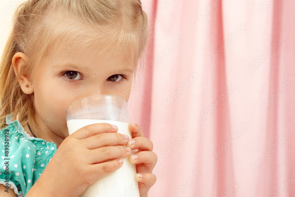 Cheerful little girl with glass of milk Cheerful little girl with glass of milk