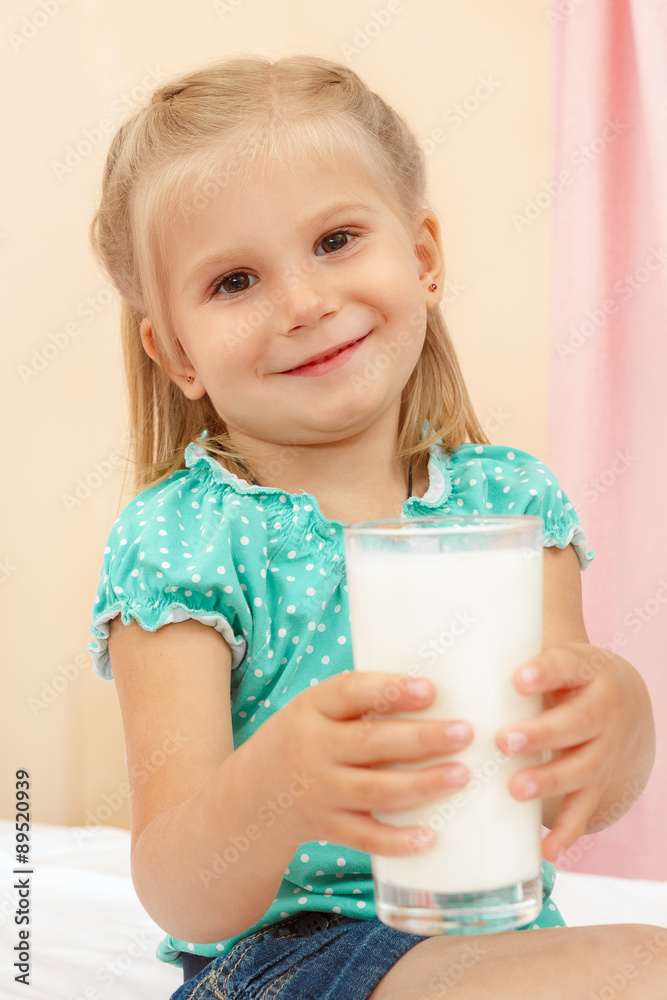 Cheerful little girl with glass of milk Cheerful little girl with glass of milk