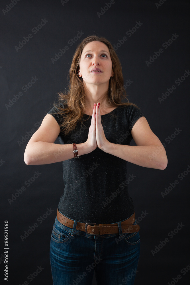 Beautiful woman doing different expressions in different sets of clothes: prayer Beautiful woman doing different expressions in different sets of clothes: prayer