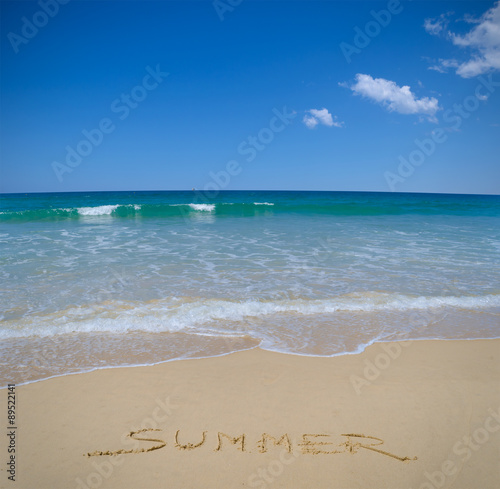 Summer written in beach sand