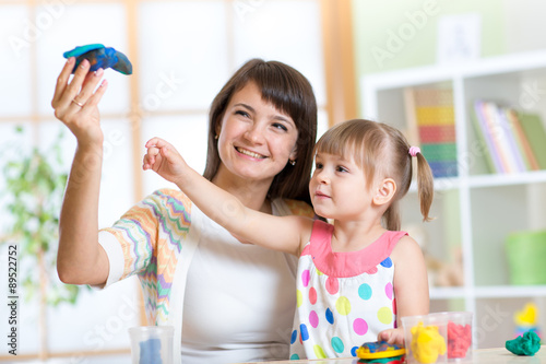 woman teaches child handcra...