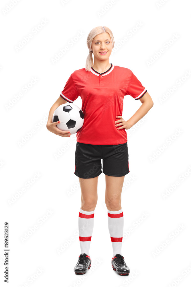 Young female football player holding a ball