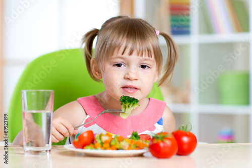 kid eating healthy food in kindergarten or at home
