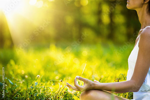 Yoga woman meditating at sunset