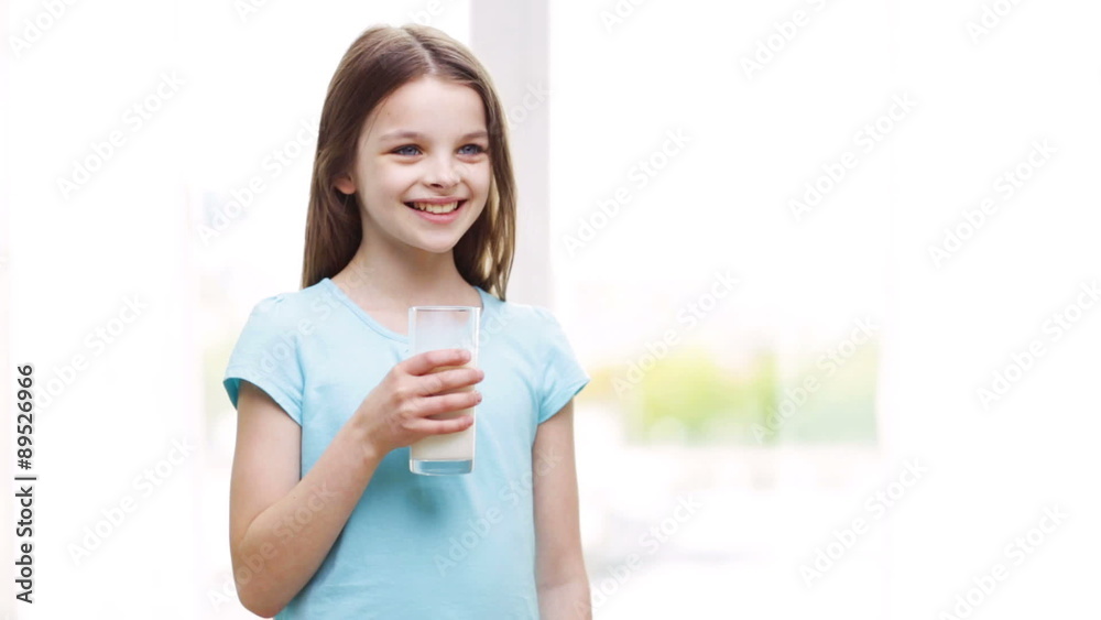 happy smiling little girl drinking milk at home happy smiling little girl drinking milk at home