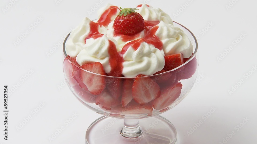 Fresh strawberries with cream in a dessert glass Fresh strawberries with cream in a dessert glass