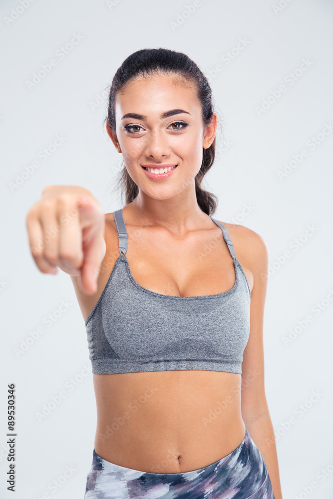 Sports woman pointing finger at camera