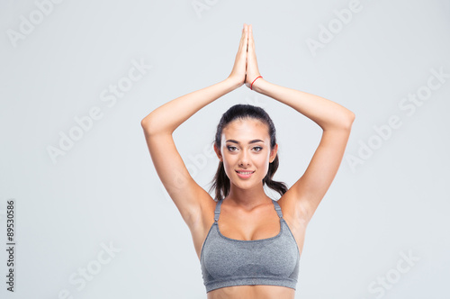 Fitness woman with joined hands over head © Drobot Dean