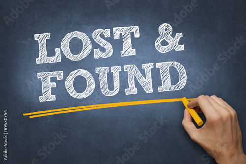 Fotografija hand writes chalk text on blackboard - LOST and FOUND