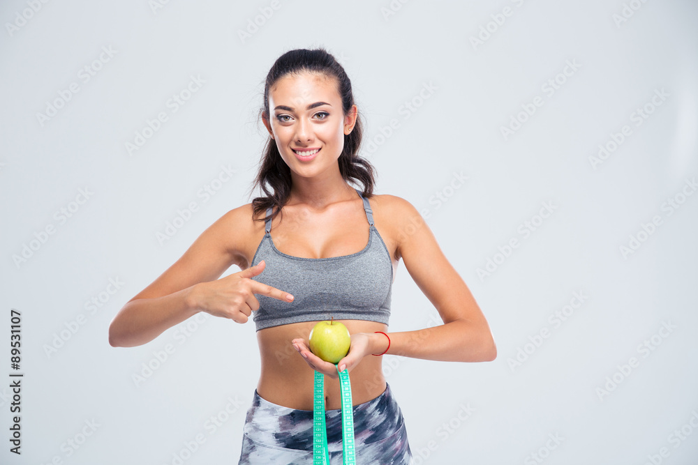 Sports woman pointing finger on apple and measuring type is Sports woman pointing finger on apple and measuring type is