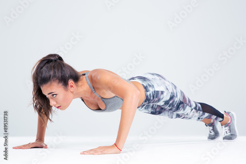 Portrait of a sports woman doing push ups